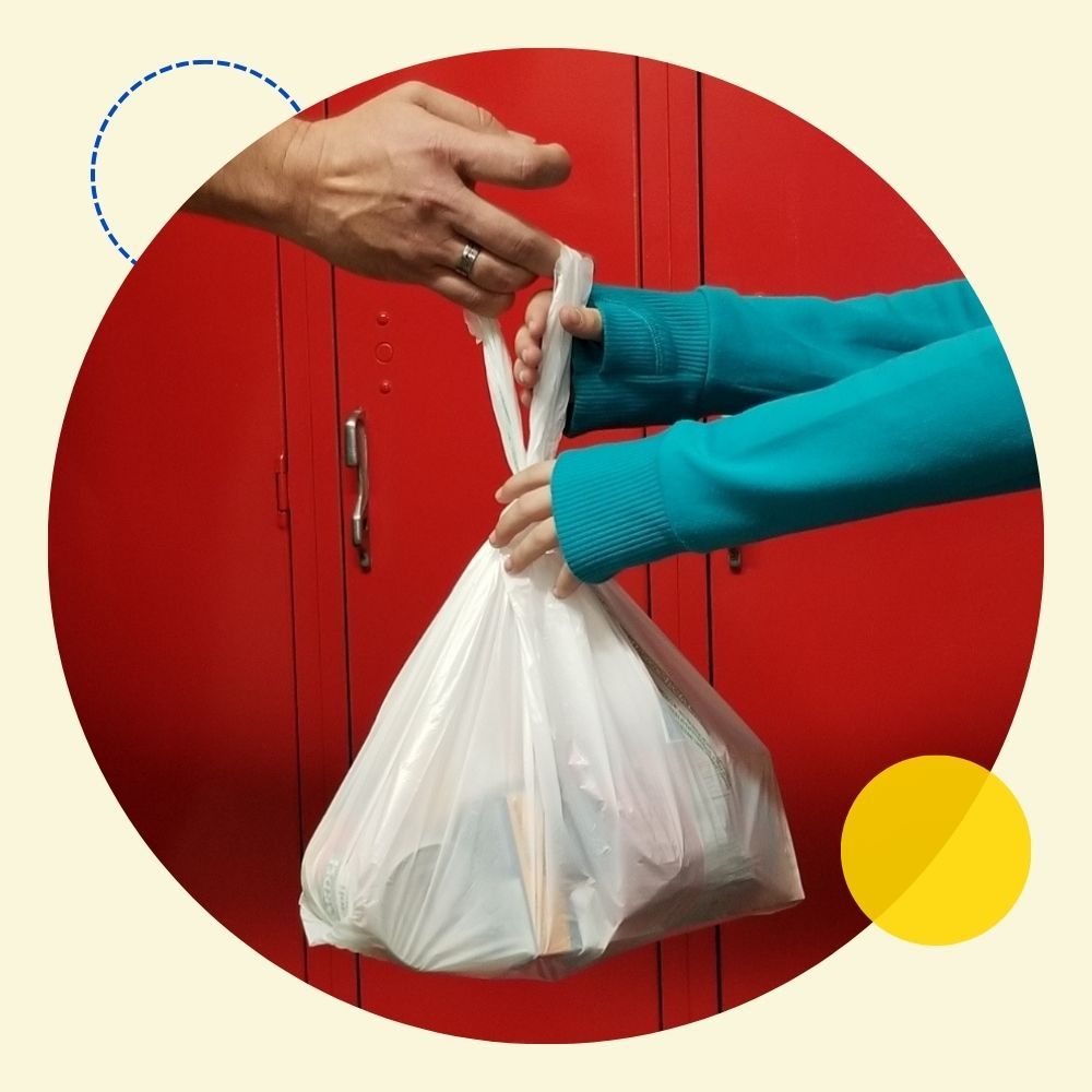 Volunteer handing food to child
